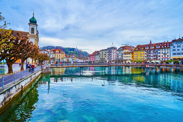 Walking embankment of Reuss river in surrounding of historical landmarks in Lucerne, Switzerland