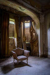 Fototapeta na wymiar Decay living room in an abandoned liberty mansion in Northern Italy