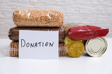 Various packages of food for donation on white background, helping needy, indigent people with food