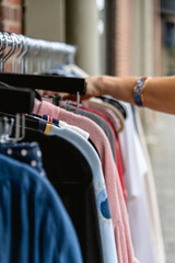 Woman Browsing Clothing Rack of Clothes
