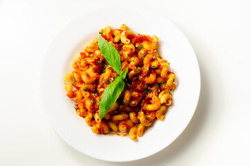 Cooked cellentani pasta with cooked chicken breast and peppers in a spicy tomato and jalapeno dressing