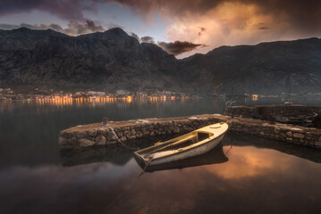 Naklejka na ściany i meble Kotor bay with beautiful reflections on water and fishing boats mountaind and colorful sky