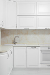Fototapeta premium Facade of white kitchen furniture in the kitchen