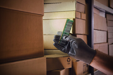 Computer chips memory ram in the hands of a man warehouse worker. The crisis of electronics...