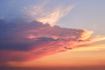 Big clouds in the red sunset sky. Evening sky in bright sunlight