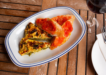 Popular Catalan dishes a delicious omelette of courgette and bread with tomatoes
