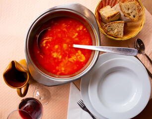Spanish food callos with chickpeas, pepper and beef tripe, served in bowl, bread at plate
