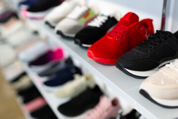 Different colorful sport shoes are on the shelves