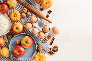 Fall pie baking ingredients with pumpkins, apples, pears, nuts, seasonal spices and tools. Cooking pumpkin or apple pie. Thanksgiving and autumn holidays celebration concept