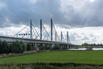 Fototapeta na wymiar The Tacitus bridge (Tacitusbrug) over the river Waal between the villages Ewijk and Herveld, the Netherlands