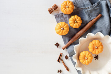 Fall pie baking ingredients with pumpkins and seasonal spices and tools. Pumpkin pie recipe idea. Thanksgiving and autumn holidays celebration concept. Top view, flatlay