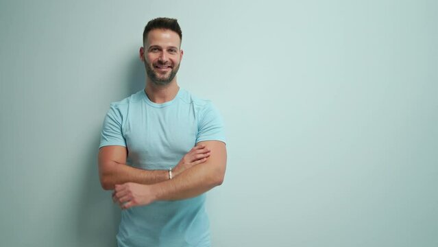 Portrait of happy casual man pointing at blank space, Young guy standing at white wall, Isolated on white background, copy space.