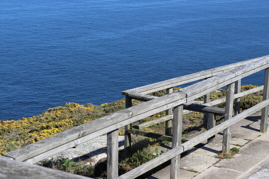 Wooden viewpoint balcony facing the sea on the Costa da Morte Cliffs, on the Camiño dos Faros hiking trail, which connects Malpica with Finisterre in Galicia, Spain.