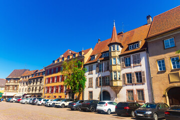 Fototapeta na wymiar View of historic center of French city of Colmar with paved streets and picturesque half-timbered houses painted in traditional Alsatian colors in summer