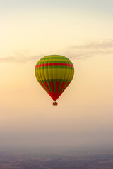 hot air balloon flying over the Moroccan desert and the atlas mountains