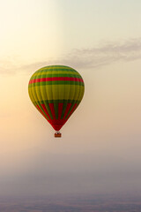 hot air balloon flying over the Moroccan desert and the atlas mountains