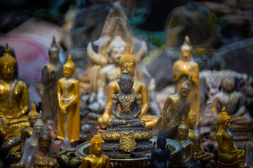 Ancient old ruin of Buddha statue carved from sandstone was destroyed and abandoned left in the Wat U Mong Temple.