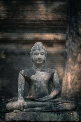 Ancient old ruin of Buddha statue carved from sandstone was destroyed and abandoned left in the Wat U Mong Temple.