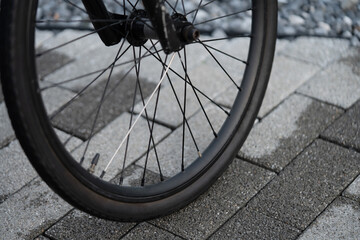 Bicycle Wheel on a Cobbled Street in Thailand.