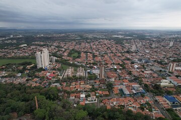 Fototapeta na wymiar Aerial photography of the city of Piracicaba. Rua do Porto, recreation parks, cars, lots of vegetation and the Piracicaba river crossing the city.