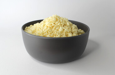 Puffed rice cereal in a grey bowl on a white background