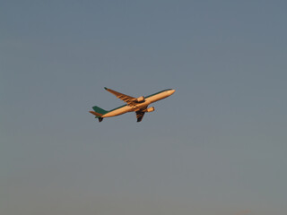 Two-Engine Commercial Jet Climbing In Clear Blue Sky