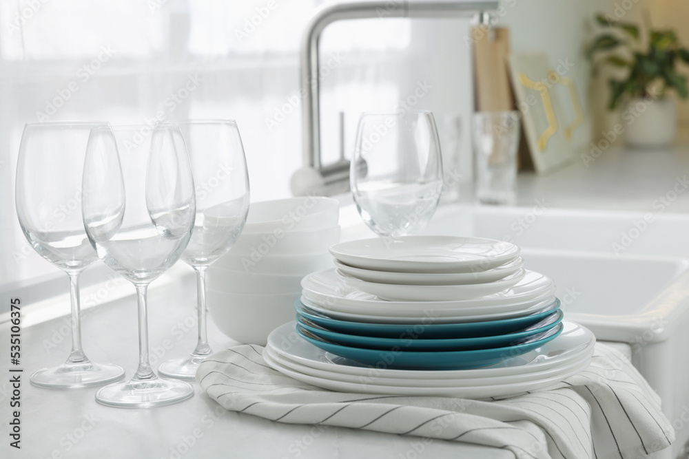 Canvas Prints Different clean dishware and glasses on countertop near sink in kitchen