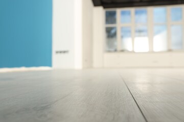 Fototapeta na wymiar Empty room with new white laminated flooring, closeup