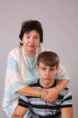 grandmother hugging her grandson on mother's day. Close-up family portrait of two generations