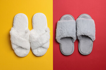 Different soft fluffy slippers on color background, flat lay