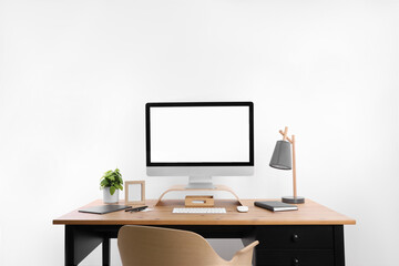 Modern computer with blank screen on desk, space for design. Comfortable workplace