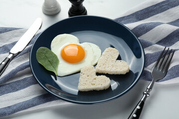 Romantic breakfast with heart shaped fried egg served on table