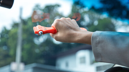 Woman use Safety Hammer and Seatbelt Cutter in Cars, break glass When emergency. In case of...