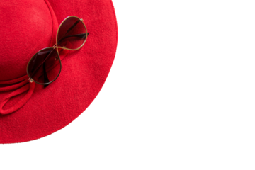 red hat on sandy beach with sunglasses, seashells and copy space for text.