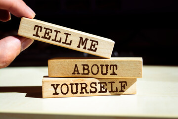 Wooden blocks with words 'Tell Me About Yourself'.