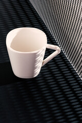 Empty white ceramic cup on circle sheet on table
