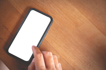 Close up men using a smartphone with an empty white screen at the wooden interior cafe.