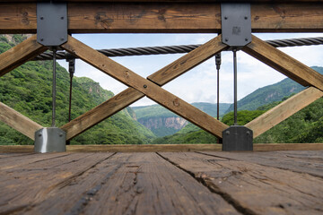 barranca huentitan, guadalajara, old wooden floor, wooden beams and crossbeams, mountains and tensioned cables, vegetation in the background