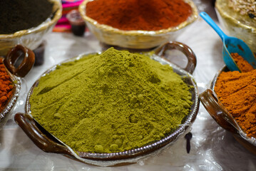 Container with mole powder. Typical Mexican food sold in a street market.