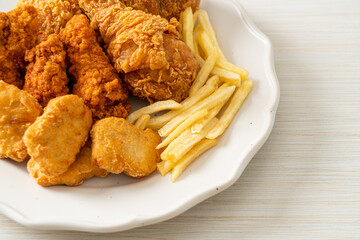 fried chicken with french fries and nuggets on plate