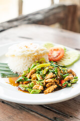 rice and stir fried chicken with basil and fried egg on top