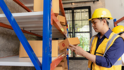 Asian man managing warehouse worker man holding tablet in warehouse Logistics network distribution and intelligent logistics, import, export, and industrial concepts..box transport