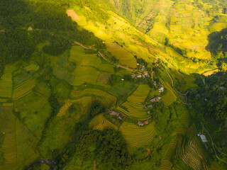Aerial view of golden rice terraces at Mu cang chai town near Sapa city, north of Vietnam. Beautiful terraced rice field in harvest season in Yen Bai, Vietnam