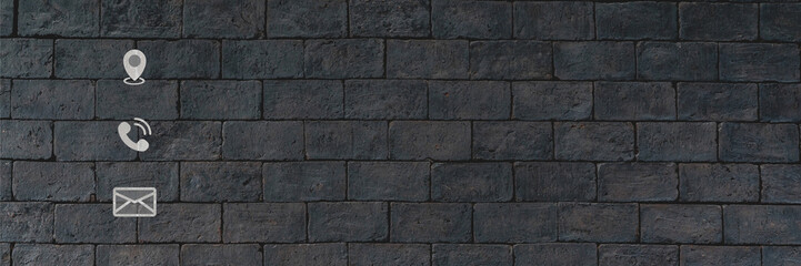 Contact us concept. Contact us page on website. Address, phone, and e-mail icons on black brick...