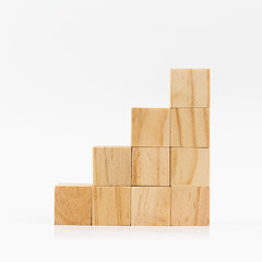 Ladder arrangement of wooden blocks on white background.