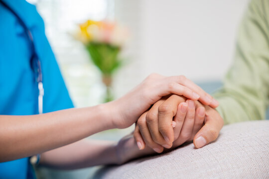 Closeup hand. Young woman helping hold hands offering her senior man, Caring nurse helping elderly old man care gets help from hospital, medical health care, International Day for the Elderly concept