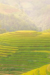 Badkamer foto achterwand Aerial view of golden rice terraces at Mu cang chai town near Sapa city, north of Vietnam. Beautiful terraced rice field in harvest season in Yen Bai, Vietnam © CravenA