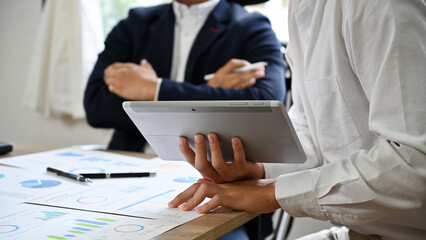 Male marketing worker presents with the board members in the meeting. cropped image