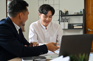 Smart Asian businessmen working, discussing and brainstorming on their project together