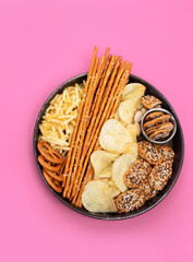 Snacks mix on color background. Top view